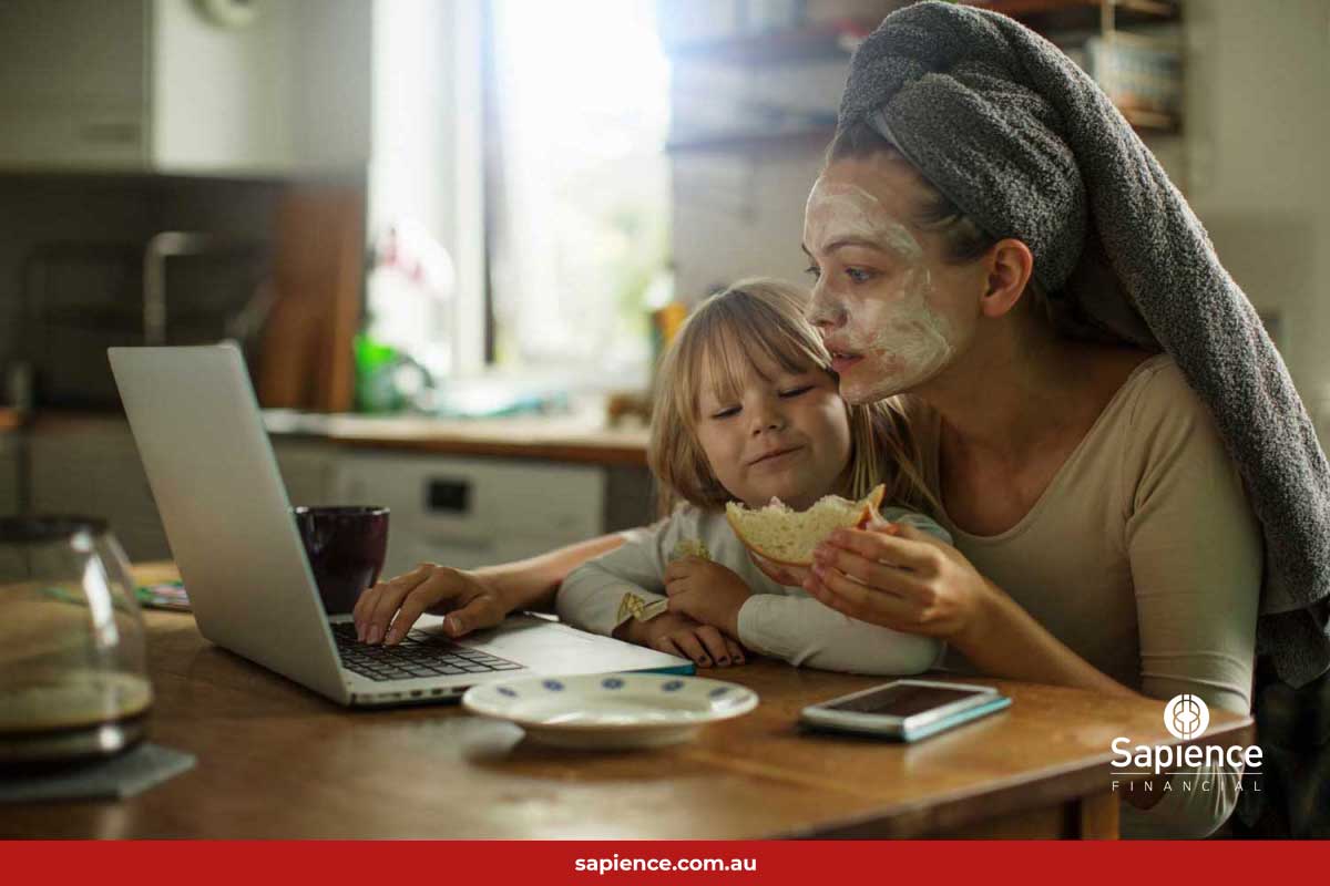 mother and child eating a sandwich in from of a laptop