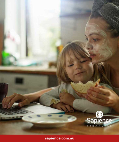 mother and child eating a sandwich in from of a laptop