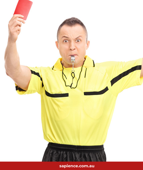 angry soccer referee blowing whistle and showing a red card