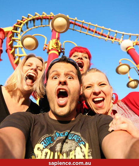 four friends on rollover coaster taking selfie