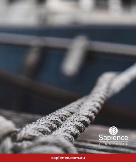sea going vessel roped to the dock straining at the mooring ropes