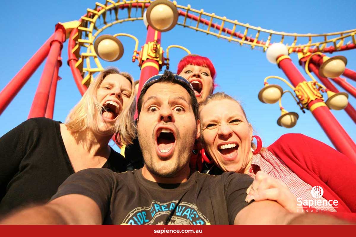 four friends on rollover coaster taking selfie