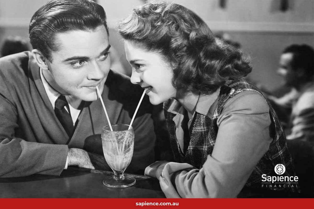 black and white of photo couple sharing single milkshake with straws