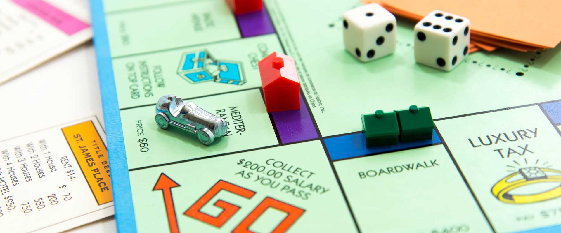 Monopoly board game with dice, money and houses