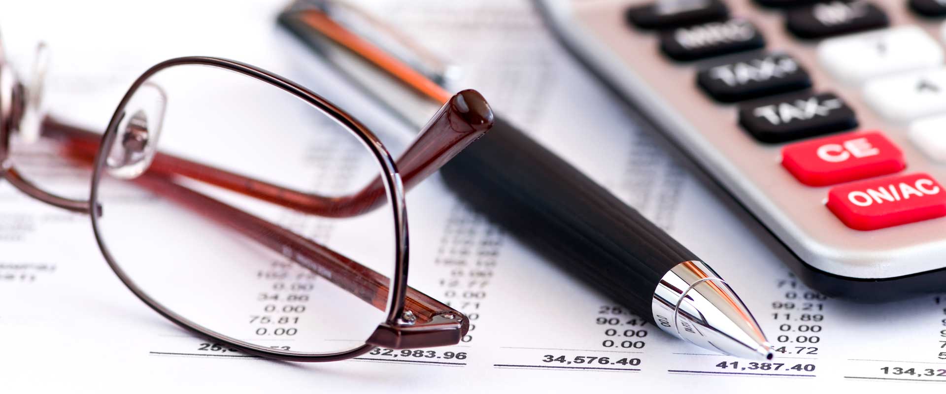 financial auditors calculator, pen and glasses