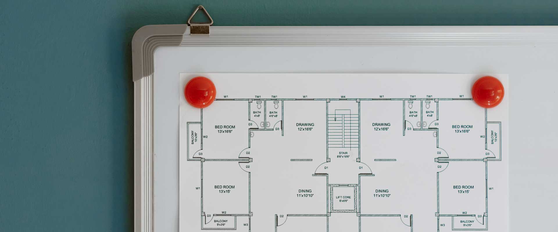 printed floor plans for house on whiteboard