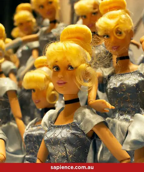 collection of seemingly identical plastic barbie dolls in silver jump suits