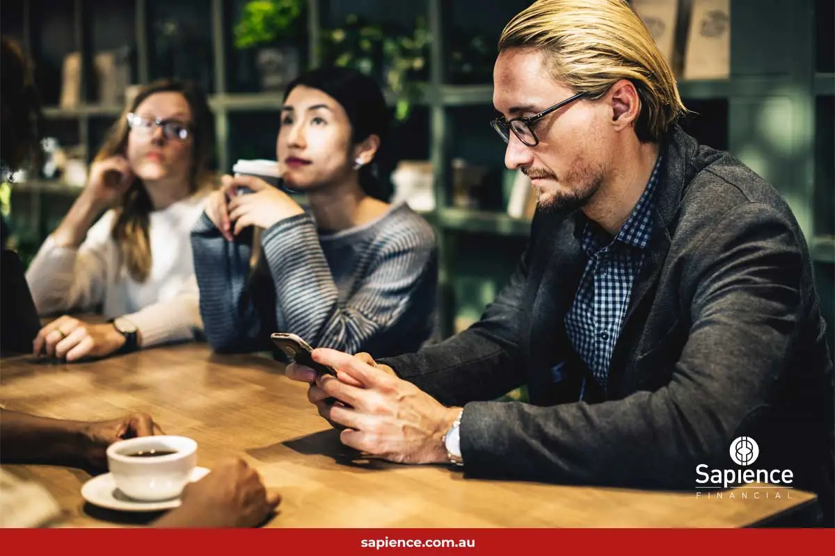 a modern businessman checks his mobile device over coffee